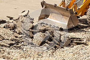 Bulldozer Dismantles Asphalt at Work