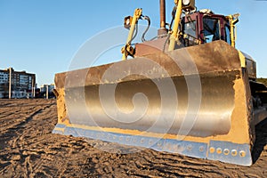 Bulldozer during earthmoving works at construction site