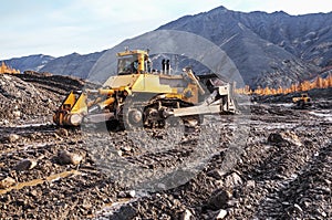 Bulldozer, earthworks in highlands, landscape, autumn.