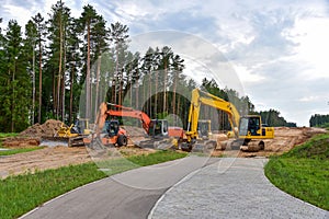 Bulldozer, Excavator and Soil compactor on road work. Earth-moving heavy equipment and Construction machinery  during land