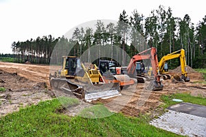 Bulldozer, Excavator and Soil compactor on road work. Earth-moving heavy equipment and Construction machinery  during land