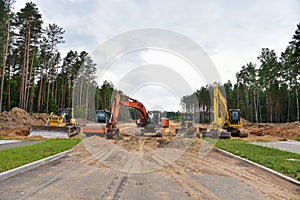 Bulldozer, Excavator and Soil compactor on road work. Earth-moving heavy equipment and Construction machinery  during land