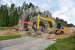 Bulldozer, Excavator and Soil compactor on road work. Earth-moving heavy equipment and Construction machinery  during land