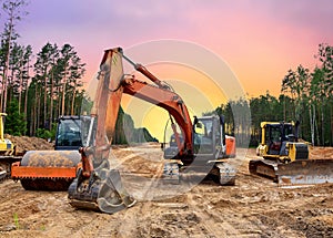 Bulldozer, Excavator and Soil compactor on road work. Earth-moving heavy equipment and Construction machinery during land clearing