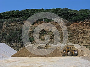 Bulldozer and heaps of sand