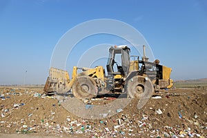 Bulldozer landfill compactor in a sanitary landfill