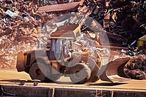 Bulldozer at a landfill with scrap metal