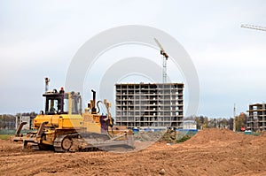 Bulldozer during of large construction jobs at building site. Land clearing, grading, pool excavation, utility trenching and