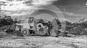 A bulldozer or loader moves the earth during the construction.