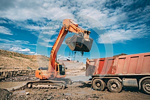 bulldozer loading dumper truck during highway construction site