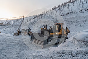 Bulldozer on a parking lot in winter time.