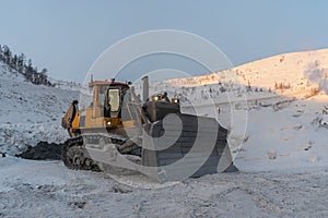 Bulldozer on a parking lot in winter time.