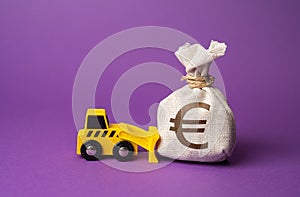 A bulldozer pushes a euro money bag.