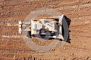 Bulldozer pushing large amount of fresh soil, Aerial shot.