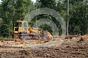 Bulldozer pushing sand photo