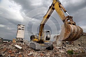 Bulldozer removes the debris from demolition of derelict buildings