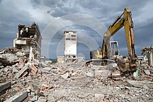 Bulldozer removes the debris from demolition of derelict buildings