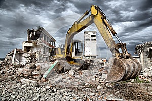 Bulldozer removes the debris from demolition of derelict buildings