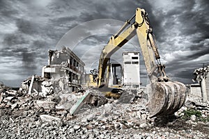 Bulldozer removes the debris from demolition of derelict buildings