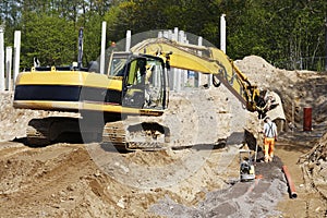 Bulldozer and site worker in action