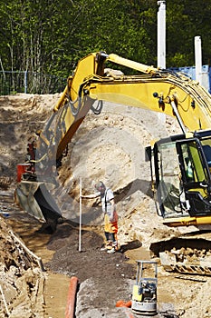 Bulldozer and site worker in action