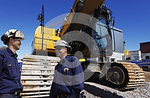 Bulldozer with site workers