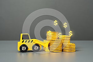 Bulldozer and a stack of coins. Deposits and savings. Invest in the project. Lose money. Confiscation and freezing of assets. photo
