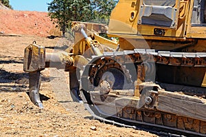 Bulldozer tracks and ripper tool.