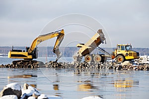 Bulldozer and truck in dredging works photo