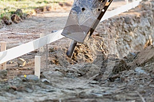 Bulldozer Using A Breaker Attachment To Dig Hole