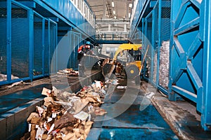 The bulldozer will clean the waste dump. Waste processing plant. Technological process. Business for sorting and