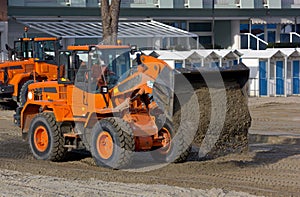 Bulldozers at Work on a Beach