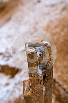 Bullet After Being Shot on The Snowy Sand Background - With Ballistic Marks