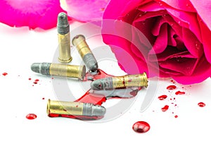 Bullet on blood and red rose on white background