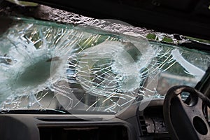 Bullet hole on a car windshield. Car window after a raid has a bullet hole. Broken glass. Bullet holes in a front windshield.
