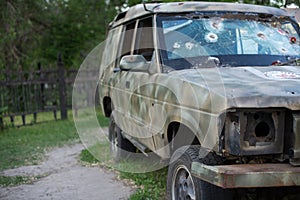 Bullet hole on a car windshield. Car window after a raid has a bullet hole. Broken glass. Bullet holes in a front windshield.