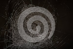 Bullet hole in glass - authentic gunshot - closeup