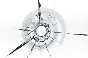 Bullet hole in glass close up on white background