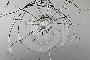 Bullet hole in the rock. Broken window, cracks