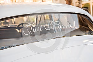 Bullet holes in car windshield with Just Married sign for newlyweds photo