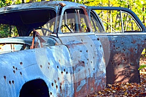 Bullet Holes in a Junk Car