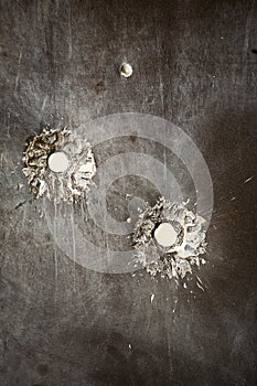 Bullet holes in metal surface