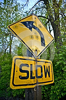 Bullet Holes Slow Down Sign