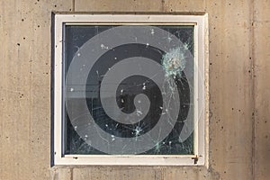 Bullet holes in the window glass of a bulletproof bunker