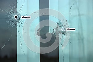 Bullet holes in windows, doors and wall after attac