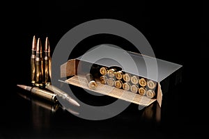 Bullet isolated on black background with reflexion. Rifle bullets close-up on black back. Cartridges for rifle and carbine on a