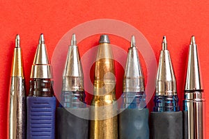 Bullet and pens on red background. Freedom of the press is at risk concept. World press freedom day concept