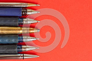 Bullet and pens on red background. Freedom of the press is at risk concept. World press freedom day concept