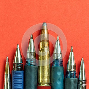 Bullet and pens on red background. Freedom of the press is at risk concept. World press freedom day concept