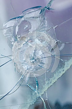 Bullethole on glass from the bullets, cracks background photo